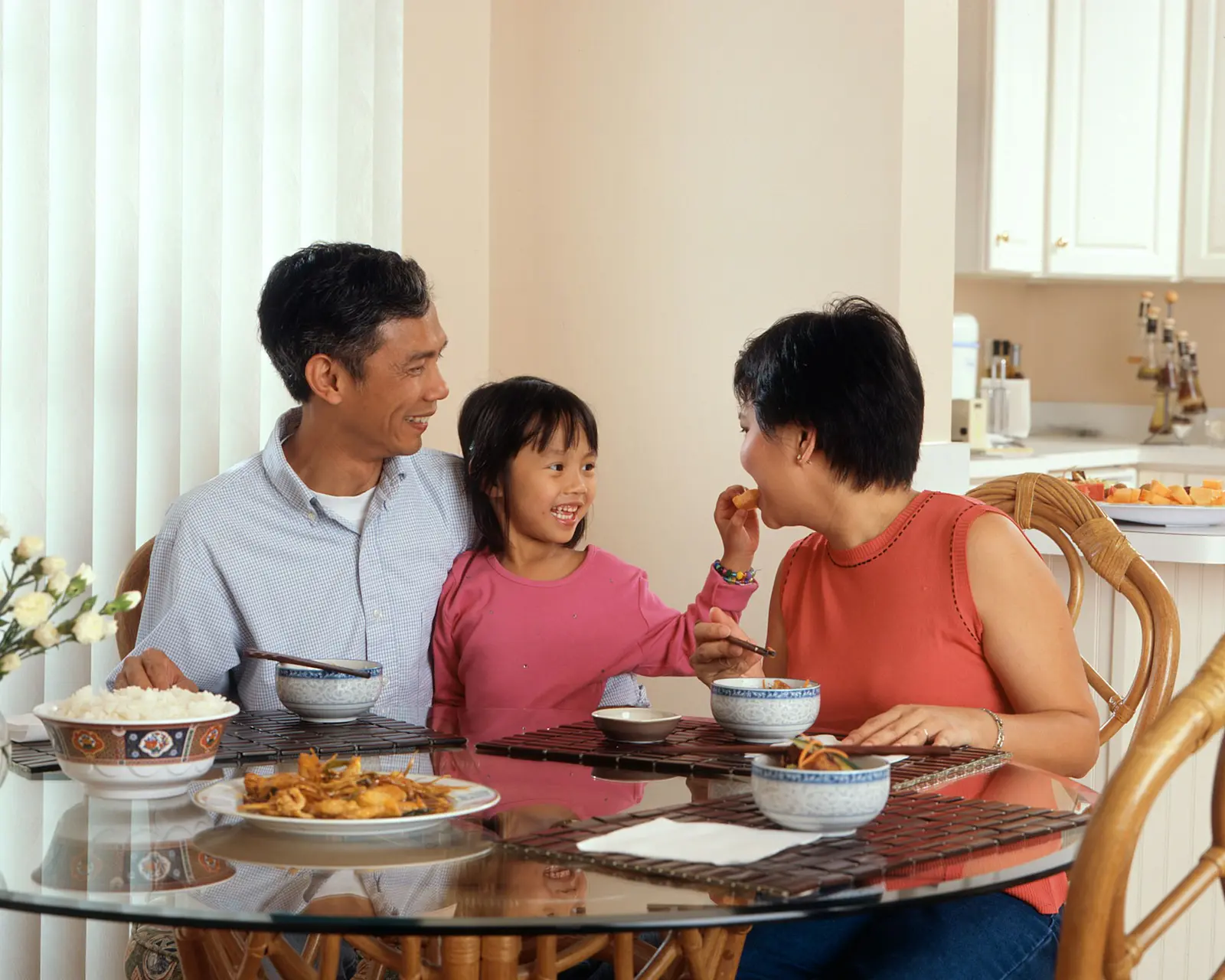 An Asian family sharing a meal at home